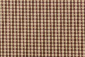 This yarn dye stripe fabric features a small plaid or checkered design in gray, taupe and washout maroon.