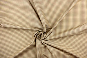 This yarn dye stripe fabric features a small plaid or checkered design in khaki, taupe and tan . 