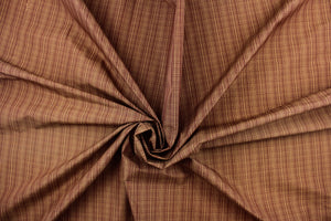  This stunning yarn dyed fabric features a small plaid design in tan and deep red. 