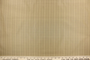  This stunning yarn dyed fabric features a small plaid design in beige and khaki. 