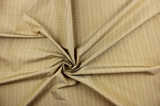  This stunning yarn dyed fabric features a small plaid design in beige and khaki. 