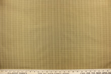 Load image into Gallery viewer, This stunning yarn dyed fabric features a small plaid design in beige, taupe and tan.
