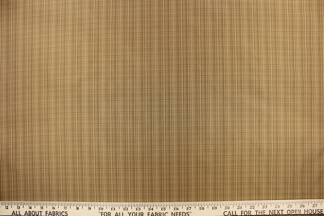 This stunning yarn dyed fabric features a small plaid design in beige and tan.