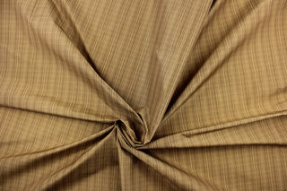 This stunning yarn dyed fabric features a small plaid design in beige and tan.