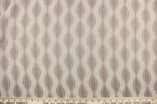 This jacquard fabric features a geometric design in beige and light brown.  