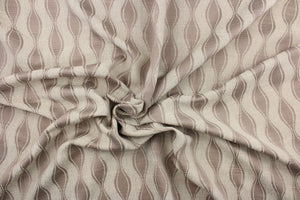 This jacquard fabric features a geometric design in beige and light brown.  