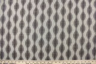 This jacquard fabric features a geometric design in graphite gray and is perfect for accent pillows, throws, blankets, window treatments (draperies and valances), and upholstery projects.