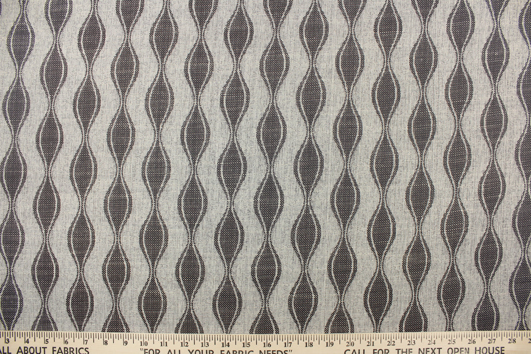 This jacquard fabric features a geometric design in graphite gray and is perfect for accent pillows, throws, blankets, window treatments (draperies and valances), and upholstery projects.