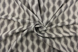 This jacquard fabric features a geometric design in graphite gray and is perfect for accent pillows, throws, blankets, window treatments (draperies and valances), and upholstery projects.