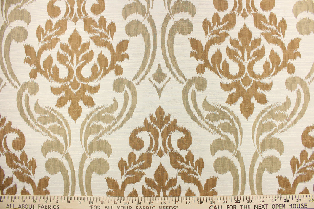 This fabric features a large medallion design in the colors of copper and dull gold on a cream background.  It has a destressed look which enhances the design.  It has a soft drapable hand and would be ideal for swags, window scarves and drapery panels.