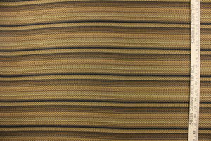   This jacquard fabric features a heavily striped pattern in shades of black, brown and gold. 