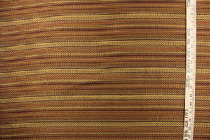This jacquard fabric features a heavily striped pattern in shades of brown, gold and orange. 