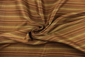 This jacquard fabric features a heavily striped pattern in shades of brown, gold and orange. 