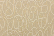 Load image into Gallery viewer, This jacquard fabric features interlocking circles in opal, beige and gold. 
