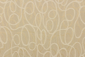 This jacquard fabric features interlocking circles in opal, beige and gold. 
