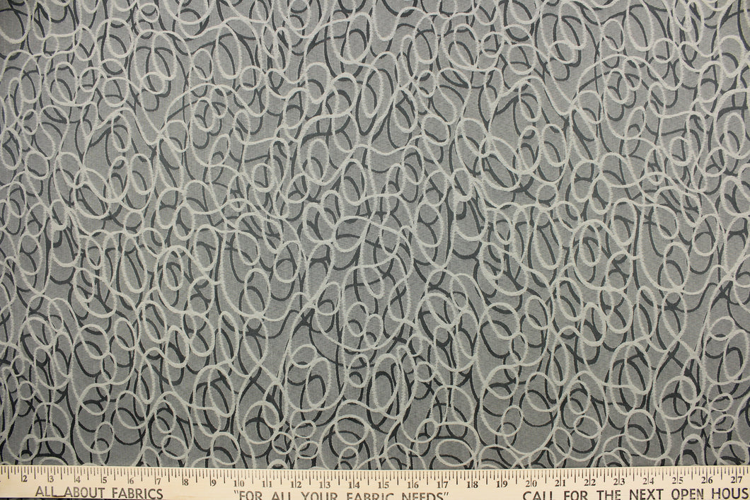 This jacquard fabric features interlocking circles in gray, stone and silver. 