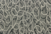 Load image into Gallery viewer, This jacquard fabric features interlocking circles in gray, stone and silver. 
