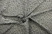 Load image into Gallery viewer, This jacquard fabric features interlocking circles in gray, stone and silver.  
