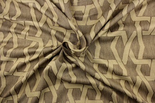 This jacquard fabric features a contemporary pattern with interlocking shapes in light brown against a chocolate brown background.  It can be used for multi purpose upholstery, bedding, accent pillows and drapery.  