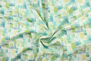 This fabric features an abstract design in greens, blues, white, and gray with hints of yellow . 