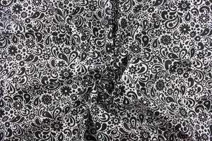  This cute and soft cotton paisley print bandana with floral accents in black against a white background.