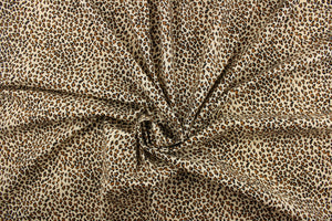 This fabric features a chic cheetah design in black, and brown. 