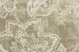 This fabric features a whimsical floral design in a off white against a grayish beige .