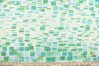 This fabric features a geometric design in beautiful shades of green and blues with white.