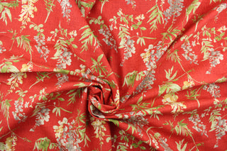 This fabric features a floral design in beige, gray, green, and cream against a red background.