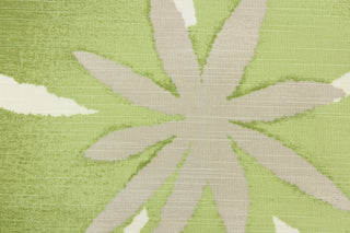 This fabric features a floral design in gray, green, beige, black, and white.