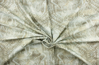This fabric features a bohemian Aztec design in pale blue, taupe, and white.