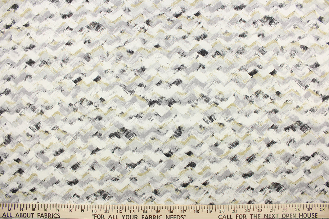 This fabric features a chevron design in light gray, black, white and a golden beige.
