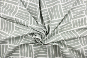 This fabric features a geometric design of thick short stripes in gray against white.