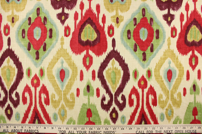 This fabric features an Ikat design in purple, light blue, green, tan, and dark pink, against a natural or light khaki. 