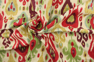 This fabric features an Ikat design in purple, light blue, green, tan, and dark pink, against a natural or light khaki. 