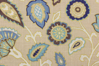 This fabric features a floral design in varying shades of blue, white, taupe, brown, and gold against a beige background.