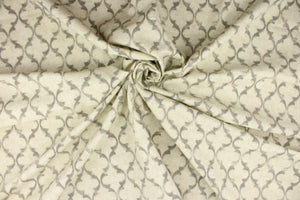 This fabric features a geometric design in gray against a natural off white. 