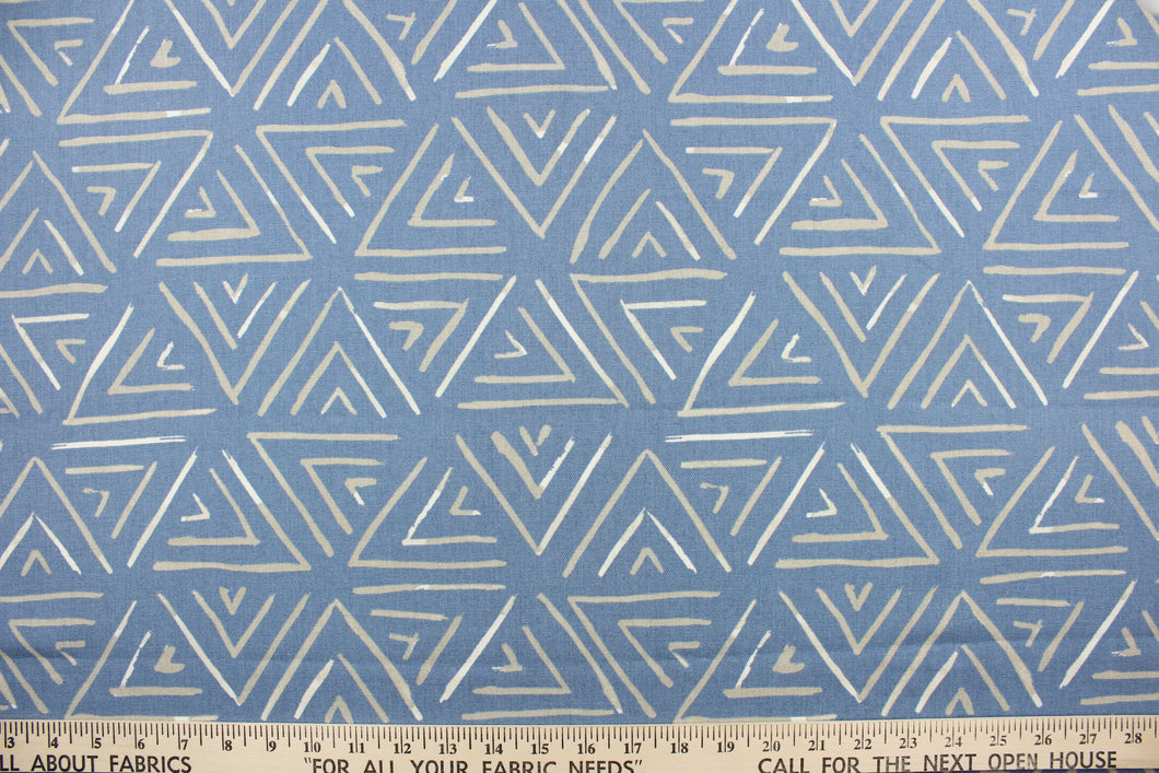 This fabric features a geometric design of triangles in gray and white against a light blue .