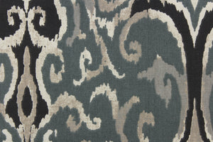 This beautiful fabric features a enteric ikat design in gray, black , taupe, off white and blue gray. 