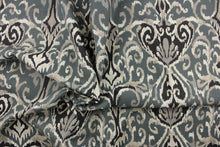 Load image into Gallery viewer,  This beautiful fabric features a enteric ikat design in gray, black , taupe, off white and blue gray. 
