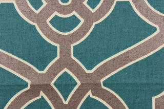 This fabric features a geometric design in dark bronze outline in off white against a teal background. 
