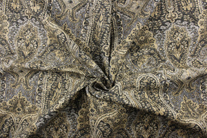 This fabric features a Persian rug design in tan, taupe, beige, gray, dark gray, and black.
