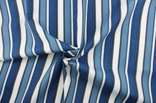 This outdoor fabric features a stripe design in white, black and varying shades of blue.