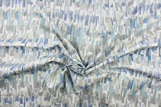 This fabric features an abstract design in shades of blue, gray and white.