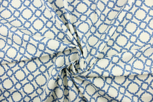 This fabric features a geometric design in blue against a dull white . 