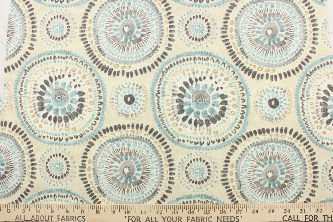 This fabric features a circular or medallion design in gray, blue, beige, white and off white .