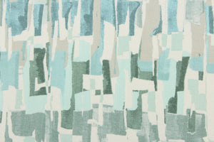 This fabric features an abstract design in light seafoam green, gray, turquoise, white and blue green. 
