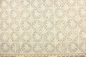 This fabric features a flower tile design in dull white and gray. 