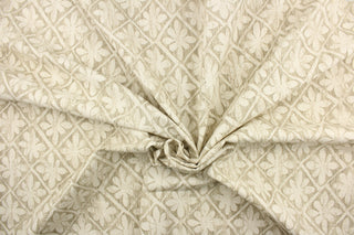 This fabric features a flower tile design in dull white and gray. 