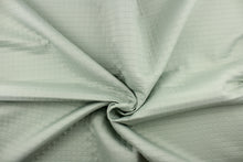 Load image into Gallery viewer, This quilted jacquard fabric in light green is durable and hard wearing with a rating of 30,000 double rubs.  
